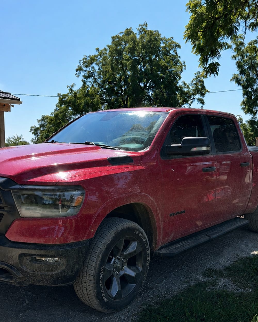 A red pickup truck before detailing, paint dull and covered in road film